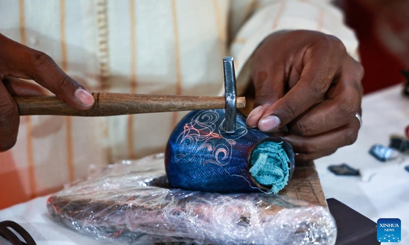 A Moroccan craftsman works on a metal handicraft at the 6th Meknes International Tourism Forum in Meknes, Morocco, Dec. 3, 2024. (Photo: Xinhua)