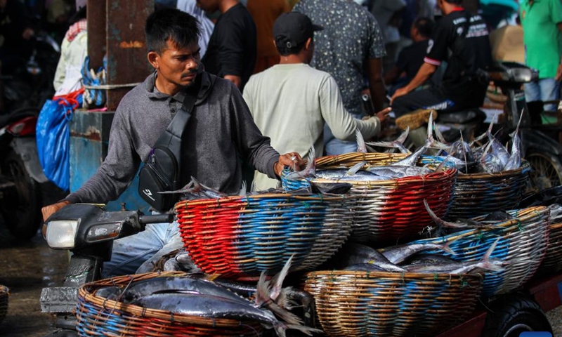 Workers ride a motorbike carrying baskets of fish in Banda Aceh, Aceh Province, Indonesia, Dec. 7, 2024. (Photo: Xinhua)