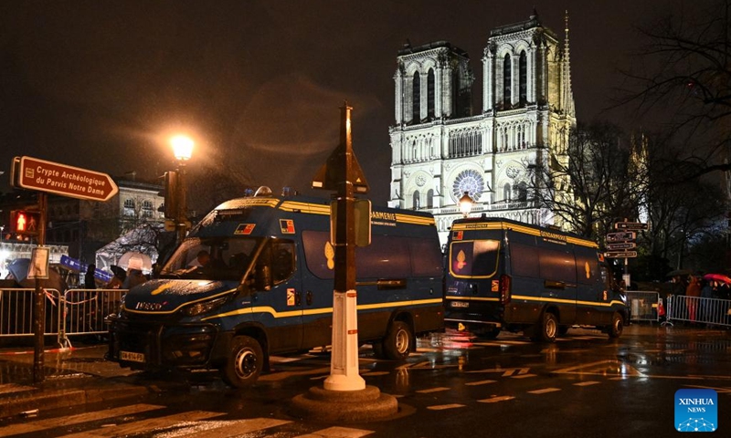 Police cars patrol near the restored Notre-Dame de Paris cathedral in the rain in Paris, France, Dec. 7, 2024. Five years after being devastated by a fire, the restored Notre-Dame de Paris cathedral officially reopened on Saturday with a grand inauguration ceremony attended by world leaders, believers, and non-believers alike. Photo: Xinhua