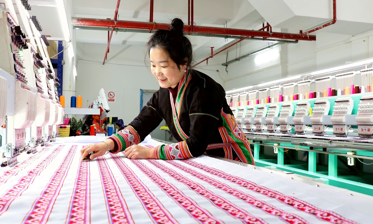 A worker produces ethnic embroidery products in a workshop in Rongjiang county, Southwest China's Guizhou Province on December 8, 2024. Miao embroidery has been recognized as part of China's first batch of national intangible cultural heritage, and it has been an important way for local villagers to increase their incomes. Photo: VCG 