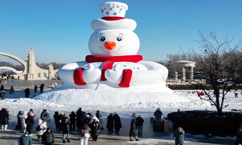 People gather around Mr. Snowman, a 20-meter tall snowman, on December 8, 2024 at the 37th Harbin Sun Island International Snow Sculpture Art Expo in Harbin, Northeast China's Heilongjiang Province. The is the first sculpture for the city's 2024 ice and snow season, media reported. Photo: VCG