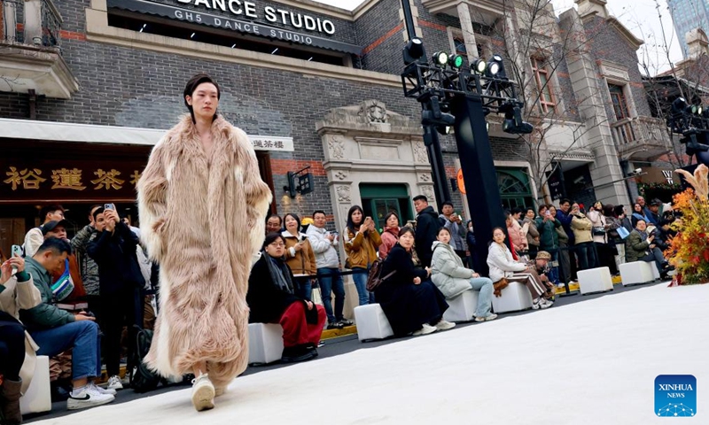 A model presents a creation during a fashion show held at Zhangyuan, or Zhang's Garden, in east China's Shanghai, Dec. 7, 2024. With the century-old Shikumen complex as the background and the Maoming North Road as the runway, a fashion show was held here on Saturday, bringing together the creations of many outstanding young designers in China. Photo: Xinhua