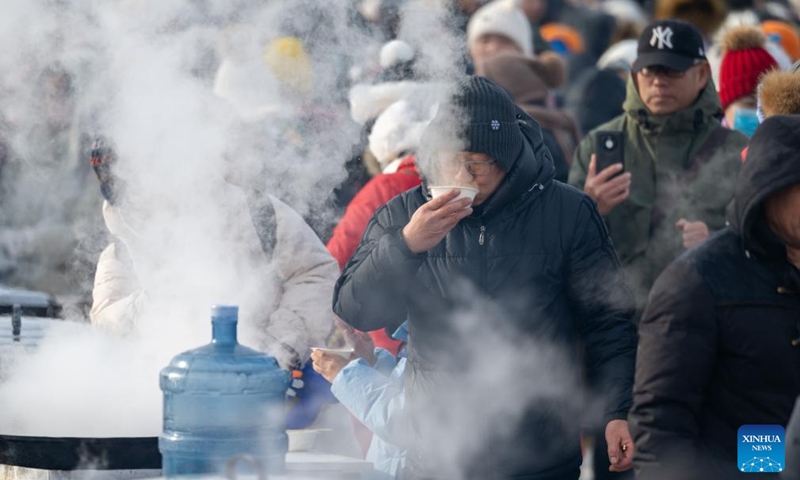 Tourists taste food during an ice collecting festival in Harbin, northeast China's Heilongjiang Province, Dec. 7, 2024. Marking the beginning of Harbin's ice collecting season, the fifth ice collecting festival kicked off here by the Songhua River on Saturday, attracting lots of people with ice collecting ceremony and performances. Photo: Xinhua