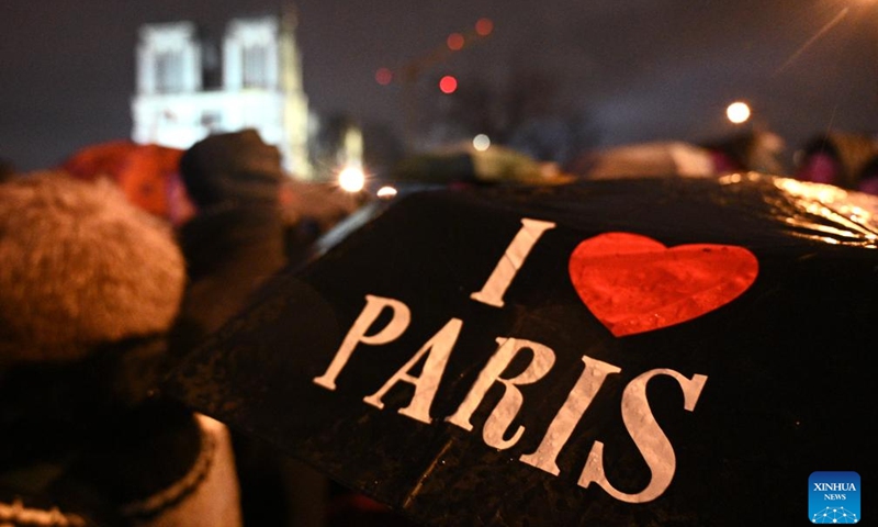 People gather outside the restored Notre-Dame de Paris cathedral in the rain in Paris, France, Dec. 7, 2024. Five years after being devastated by a fire, the restored Notre-Dame de Paris cathedral officially reopened on Saturday with a grand inauguration ceremony attended by world leaders, believers, and non-believers alike. Photo: Xinhua