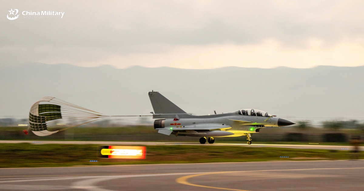 A J-10 fighter jet attached to an aviation brigade with the air force under Chinese PLA Southern Theater Command slows down with drag parachute after landing on the runway in a nighttime flight training exercise. The exercise started at midnight and lasted until dawn. (eng.chinamil.com.cn/Photo by Wang Guoyun)