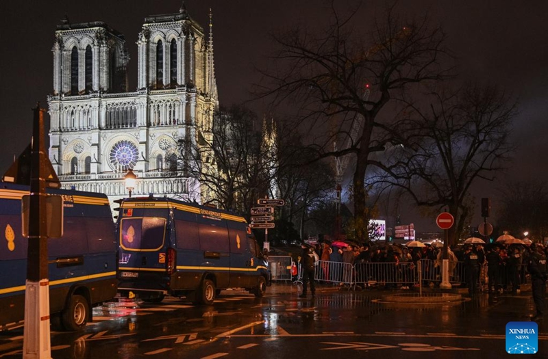 People gather outside the restored Notre-Dame de Paris cathedral in the rain in Paris, France, Dec. 7, 2024. Five years after being devastated by a fire, the restored Notre-Dame de Paris cathedral officially reopened on Saturday with a grand inauguration ceremony attended by world leaders, believers, and non-believers alike. Photo: Xinhua