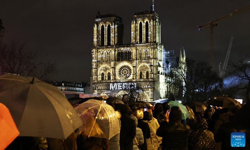 People gather outside the restored Notre-Dame de Paris cathedral in the rain in Paris, France, Dec. 7, 2024. Five years after being devastated by a fire, the restored Notre-Dame de Paris cathedral officially reopened on Saturday with a grand inauguration ceremony attended by world leaders, believers, and non-believers alike. Photo: Xinhua