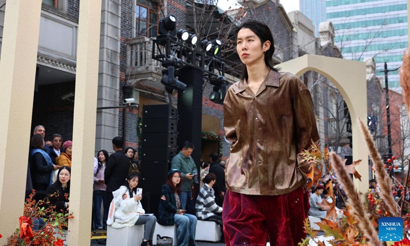 A model presents a creation during a fashion show held at Zhangyuan, or Zhang's Garden, in east China's Shanghai, Dec. 7, 2024. With the century-old Shikumen complex as the background and the Maoming North Road as the runway, a fashion show was held here on Saturday, bringing together the creations of many outstanding young designers in China. Photo: Xinhua