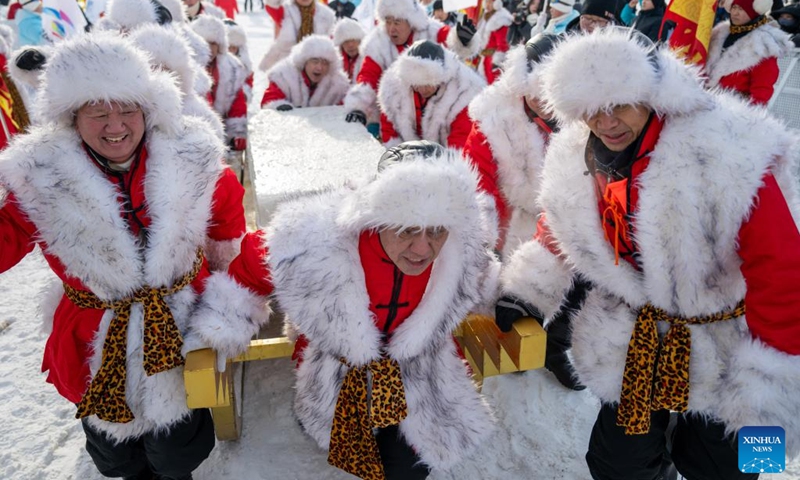 Ice collecting crew transport an ice cube during an ice collecting festival in Harbin, northeast China's Heilongjiang Province, Dec. 7, 2024. Marking the beginning of Harbin's ice collecting season, the fifth ice collecting festival kicked off here by the Songhua River on Saturday, attracting lots of people with ice collecting ceremony and performances. Photo: Xinhua