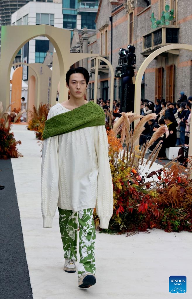 A model presents a creation during a fashion show held at Zhangyuan, or Zhang's Garden, in east China's Shanghai, Dec. 7, 2024. With the century-old Shikumen complex as the background and the Maoming North Road as the runway, a fashion show was held here on Saturday, bringing together the creations of many outstanding young designers in China. Photo: Xinhua