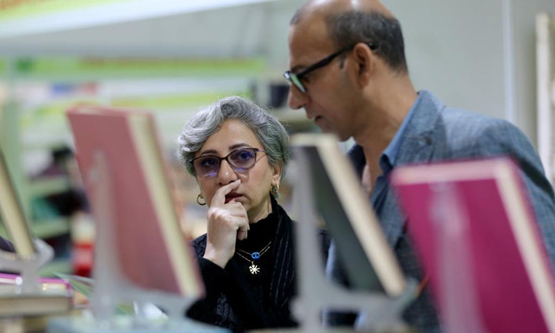 Visitors look at books at the Iraq International Book Fair in Baghdad, Iraq, on Dec. 7, 2024. Photo: Xinhua