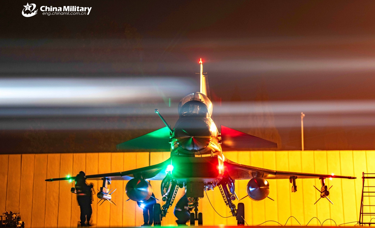 Ground crew members assigned to an aviation brigade with the air force under Chinese PLA Southern Theater Command inspect a J-10 fighter jet during a nighttime flight training exercise. The exercise started at midnight and lasted until dawn. (eng.chinamil.com.cn/Photo by Wang Guoyun)