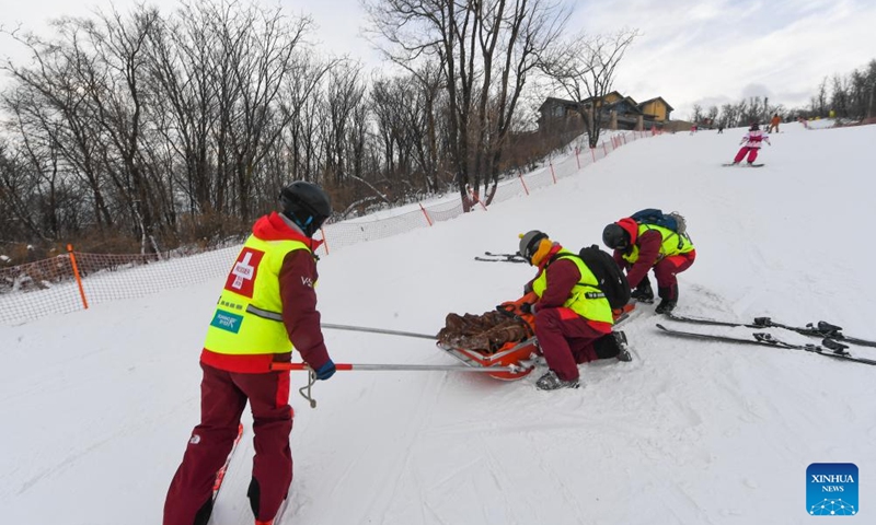 Yao He (1st L) and his colleagues use a rescue sled to transfer a skier down the ski slopes at Lake Songhua Resort in Jilin City, northeast China's Jilin Province, Dec. 5, 2024. Photo: Xinhua