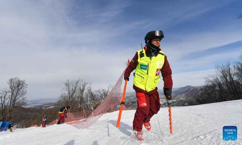 Yao He sets up protective facilities with his colleagues at Lake Songhua Resort in Jilin City, northeast China's Jilin Province, Dec. 5, 2024. Yao He, 31, is the head of the skiing rescuer team at the Lake Songhua Resort in Jilin. He chose this profession in 2016 due to his love for skiing. With the arrival of the skiing season, Yao leads his team to inspect the ski slopes and identify potential safety hazards every day before the opening of the ski resort. After the resort opens, they closely monitor the flow of people and always prepare to rescue skiers in need. The occupation of skiing rescuer was among the 19 new occupations announced by China's Ministry of Human Resources and Social Security in July 2024. With the increasing popularity of skiing, the importance of ensuring skiing safety has been emphasized. As a skiing rescuer, I will continue to increase my professional skills and provide a safe environment for skiers to have fun, Yao said. Photo: Xinhua