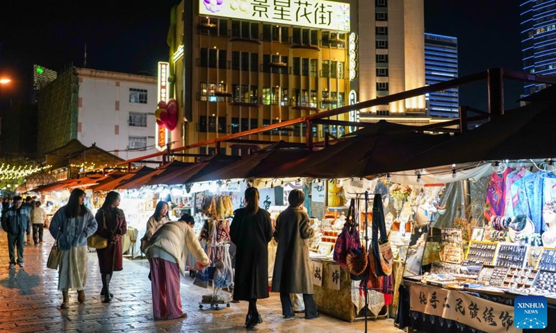 Tourists visit a night fair on a street in Kunming City, southwest China's Yunnan Province, Dec. 6, 2024. In recent years, Kunming has stepped up its efforts to enrich citizen's life by developing night fair compounds. Photo: Xinhua