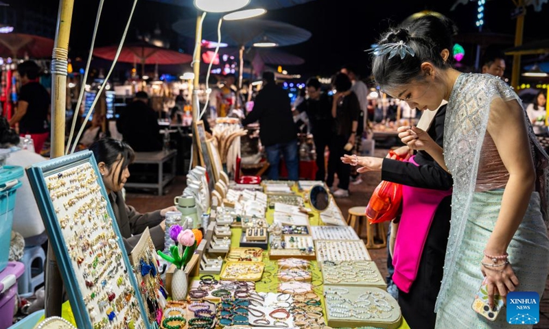 Tourists visit the Starlight Night Market in Jinghong City of Xishuangbanna Dai Autonomous Prefecture, southwest China's Yunnan Province, Dec. 7, 2024. The night market is a destination to experience the customs of Dai ethnic group. Photo: Xinhua