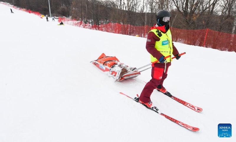 Yao He uses a rescue sled to transfer a skier down the ski slopes at Lake Songhua Resort in Jilin City, northeast China's Jilin Province, Dec. 5, 2024. Photo: Xinhua