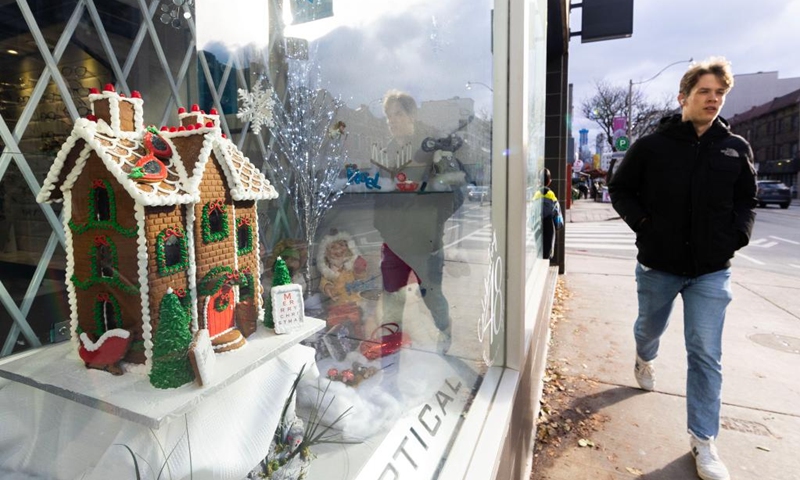 A man walks past a shop window displaying a gingerbread house during the 2024 Toronto Gingerbread Festival in Toronto, Canada, on Dec. 8, 2024. The week-long event is held here from Dec. 3 to 10, showcasing 16 professionally-designed gingerbread houses at select storefront windows. Photo: Xinhua