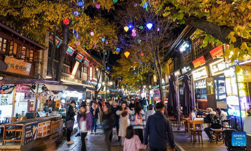 Tourists stroll on a commercial street at night in Kunming City, southwest China's Yunnan Province, Dec. 6, 2024. In recent years, Kunming has stepped up its efforts to enrich citizen's life by developing night fair compounds. Photo: Xinhua