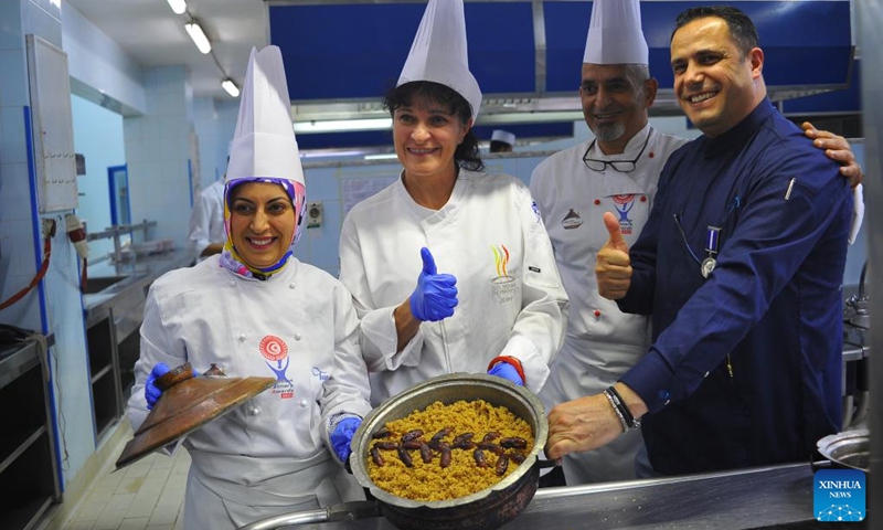 Chefs show couscous, a traditional food, during a food competition in Hammamet, eastern Tunisia, on Dec. 9, 2024. A couscous food competition is held here from Dec. 4 to Dec. 10. (Photo:Xinhua)