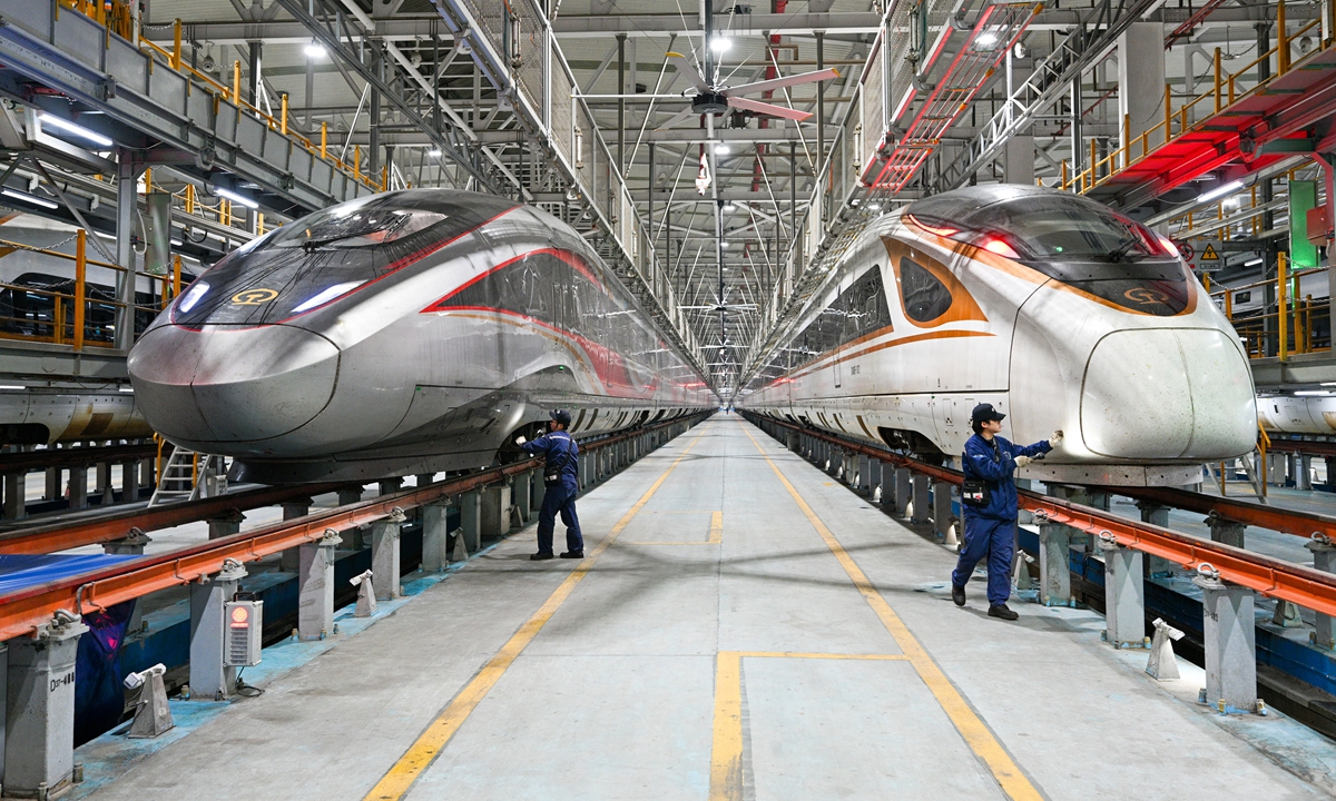 Ground maintenance technicians repair high-speed trains in a maintenance workshop in Nanjing, East China's Jiangsu Province, on December 10, 2024. In response to the winter cold wave, maintenance work is being carried out with a focus on key systems such as the high-voltage traction system, air conditioning and heating, air supply, and braking pipeline systems, to ensure the safe and smooth operation of the trains. Photo: IC