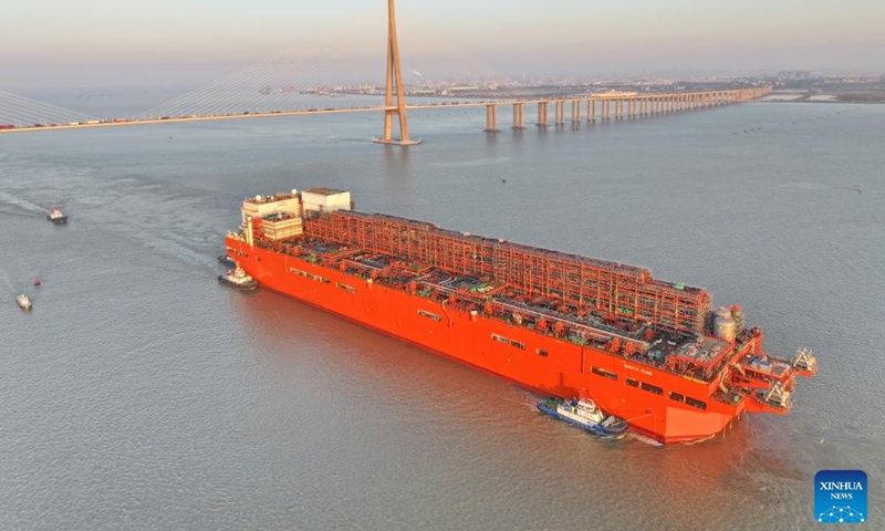 This aerial drone photo taken on Dec. 9, 2024 shows the NGUYA FLNG, a floating liquified natural gas (FLNG) facility, being tugged through the Sutong (Suzhou-Nantong) Bridge across the Yangtze River in east China's Jiangsu Province. (Photo: Xinhua)