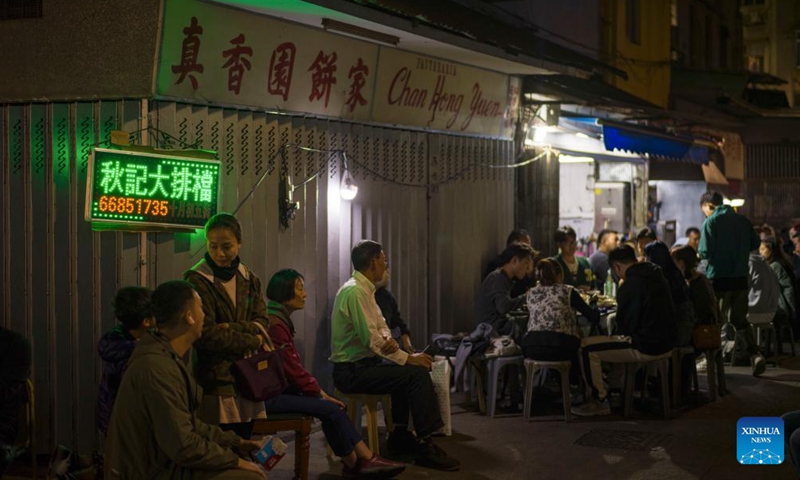 People wait outside a Dai Pai Dong street food stall in Macao, south China, Dec. 8, 2024. (Photo: Xinhua)