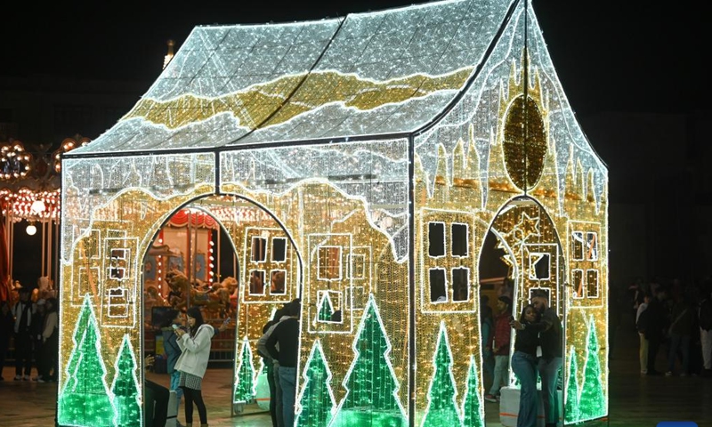 People are seen in a light decoration at a Christmas fairyland in Valletta, Malta, on Dec. 10, 2024. (Photo: Xinhua)