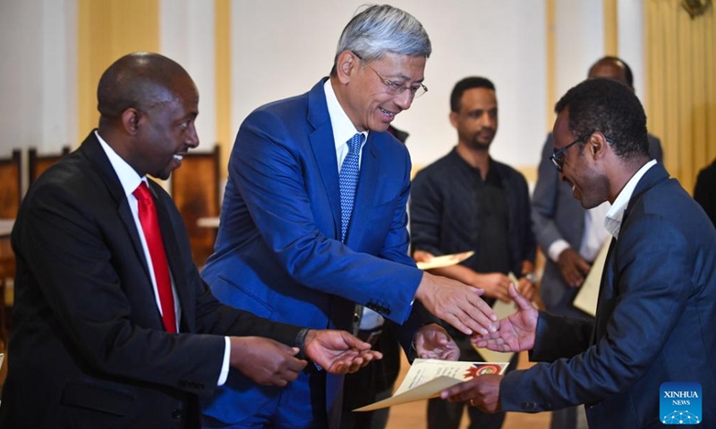 Guests present certificates to scholarship recipients at the award ceremony of the China-Ethiopia Friendship Scholarship at the Addis Ababa University in Addis Ababa, Ethiopia on Dec. 10, 2024. Hundreds of Ethiopian university students have been awarded Chinese scholarships to help them pursue graduate and post-graduate studies across different academic fields in the East African country's prestigious Addis Ababa University (AAU). (Photo: ecns.cn)