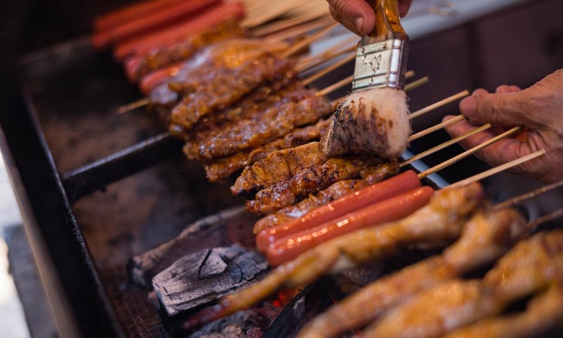 A roast shop worker prepares kebab in Macao, south China, Dec. 8, 2024.

As a popular destination renowned for its various delicacies, Macao lives up to any tourist's expectations for a tasty trip. Visitors can learn about Macao's culinary traditions through a taste of its quintessential street food. (Photo: Xinhua)