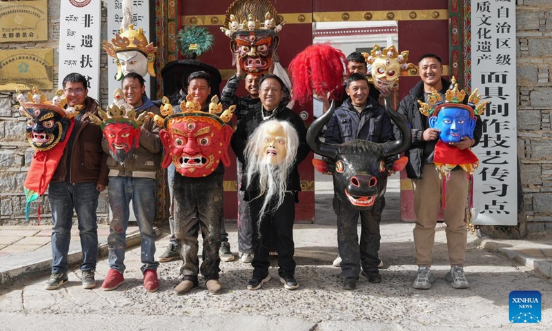 Craftsmen pose for a group photo in front of a cooperative in Dagze District of Lhasa, southwest China's Xizang Autonomous Region, Dec. 9, 2024. (Photo: Xinhua)