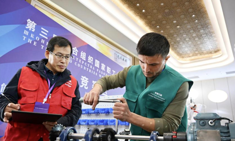 Rustam Sharipov (R) from Uzbekistan competes in the third SCO Countries Worker Skills Contest in Qingdao, east China's Shandong Province, Dec. 18, 2024. The contest kicked off on Wednesday in Qingdao, attracting skilled workers competing in three programs. (Xinhua/Li Ziheng)