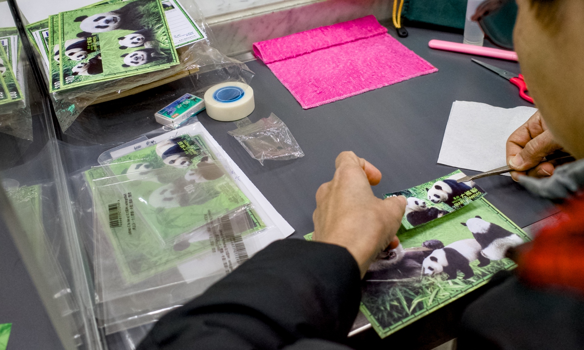 A citizen purchases panda-themed stamps and philatelic items at the General Post Office in Central, Hong Kong Special Administrative Region, on December 12, 2024. On the same day, the General Post Office began selling a set of stamps and souvenir sheets themed 