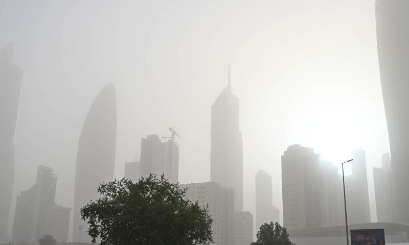 Buildings are pictured during a dust storm in Kuwait City, Kuwait, Dec. 15, 2024. (Photo by Asad/Xinhua)