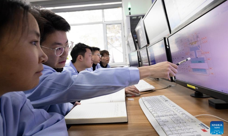 Researchers analyze experimental data at the control room of the low-energy high-intensity heavy-ion accelerator facility (LEAF) on Dec. 10, 2024. (Photo: Xinhua)