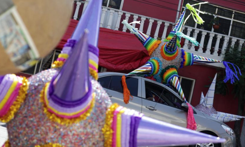 This photo taken on Dec. 13, 2024 shows Christmas pinatas in Mexico City, Mexico. Pinata, traditionally crafted in the shape of a seven-pointed star, is filled with candies and small gifts, bringing joy and festive spirit to celebrations. (Xinhua/Francisco Canedo)