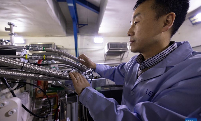 Sun Liangting, a researcher with the Institute of Modern Physics of the Chinese Academy of Sciences, checks equipment on Dec. 10, 2024. (Photo: Xinhua)