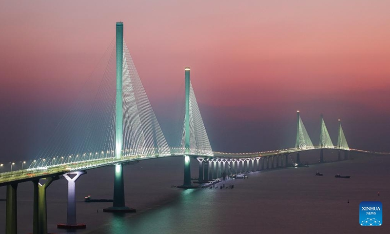 An aerial drone photo taken on Dec. 7, 2024 shows a view of Gaolan Port Bridge (with twin main towers on the left) and Huangmaohai Bridge (with three main towers on the right) in south China's Guangdong Province.(Photo: Xinhua)