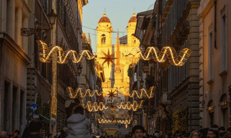 People visit Via dei Condotti decorated with festive lights in Rome, Italy, Dec. 17, 2024. (Xinhua/Li Jing)