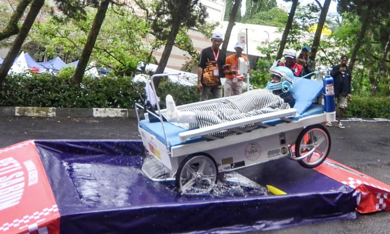 A participant drives a home-made vehicle without the engine in fun race category during the Bandung SoapBox Race 2024 in Bandung, West Java, Indonesia, Dec. 15, 2024. (Photo by Septianjar Muharam/Xinhua)