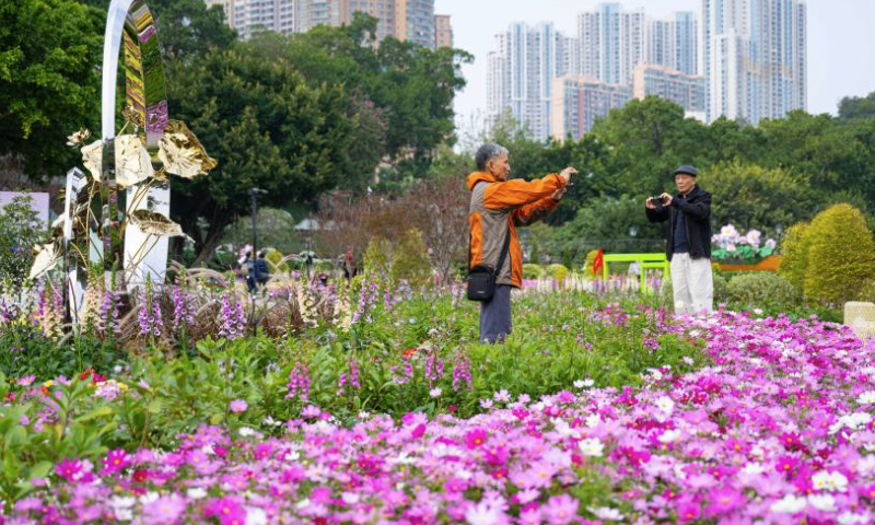 Visitors take photos at a flower show on Taipa Island in Macao, south China, Dec. 14, 2024. A flower show celebrating the 25th anniversary of Macao's return to the motherland kicked off here on Saturday, and will run until Jan. 5, 2025. (Xinhua/Cheong Kam Ka)