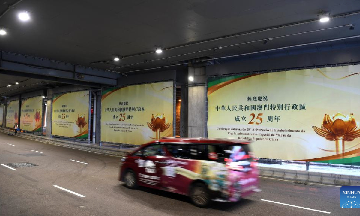 Celebration posters are seen at Macao International Airport in Macao, south China, Dec. 17, 2024. The streets of Macao have been adorned by festive decorations, as the city is set to mark the 25th anniversary of its return to the motherland. (Xinhua/Chen Duo)