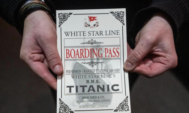 A staff member displays a sample ticket, which is a replica of an original Titanic boarding pass, at a Titanic artifact exhibition in Boston, Massachusetts, the United States, Dec. 13, 2024. The exhibition features more than 200 authentic artifacts recovered from the shipwreck. (Photo by Ziyu Julian Zhu/Xinhua)