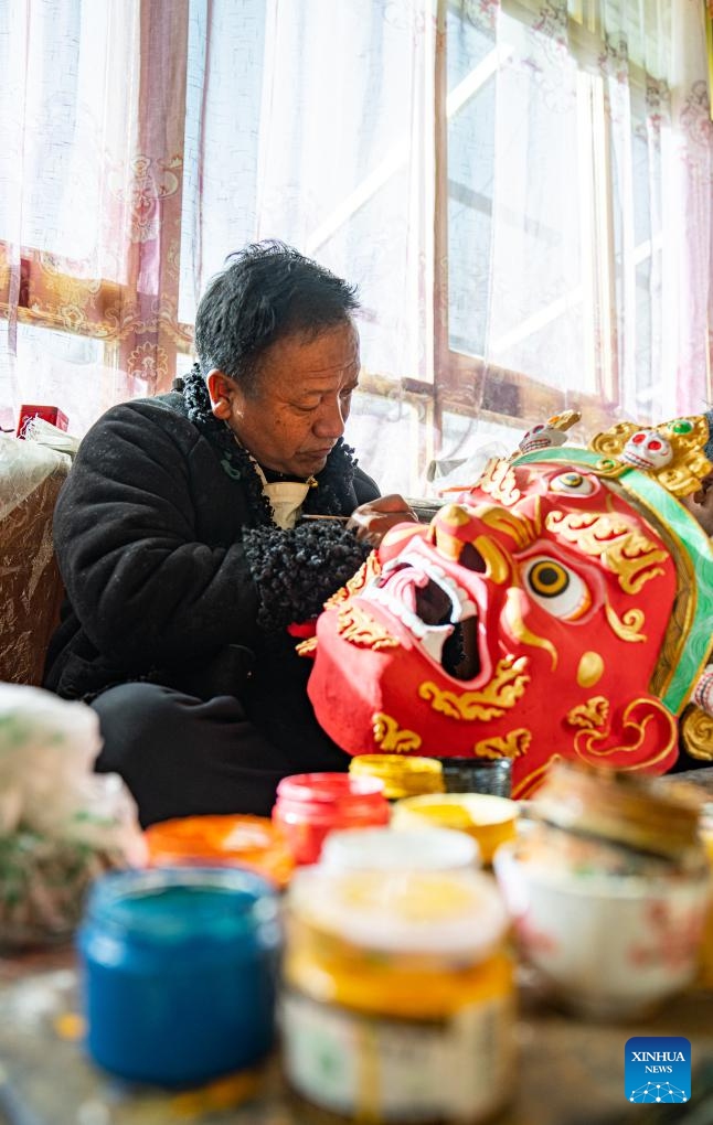 Shilok crafts a traditional Tibetan mask at a cooperative in Dagze District of Lhasa, southwest China's Xizang Autonomous Region, Dec. 9, 2024. (Photo: Xinhua)