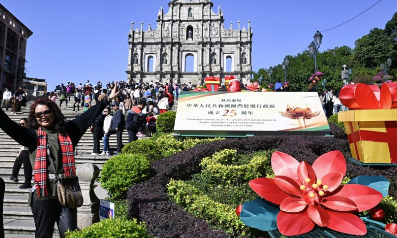 A celebration installation is seen in front of the Ruins of St. Paul's in Macao, south China, Dec. 18, 2024. The streets of Macao have been adorned by festive decorations, as the city is set to mark the 25th anniversary of its return to the motherland. (Xinhua/Cheng Yiheng)