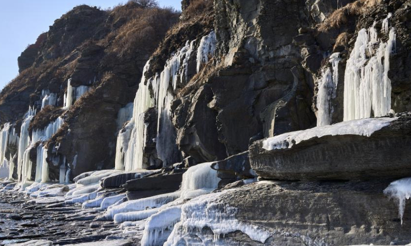 This photo taken on Dec. 18, 2024 shows icefalls by the sea in Vladivostok, Russia. As the temperature continues to drop in winter, massive icefalls are formed on the seashore of Vladivostok. (Photo by Guo Feizhou/Xinhua)