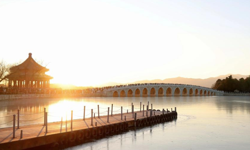 People visit the 17-Arch Bridge in the Summer Palace in Beijing, capital of China on Dec. 22, 2024. (Xinhua/Xing Guangli)