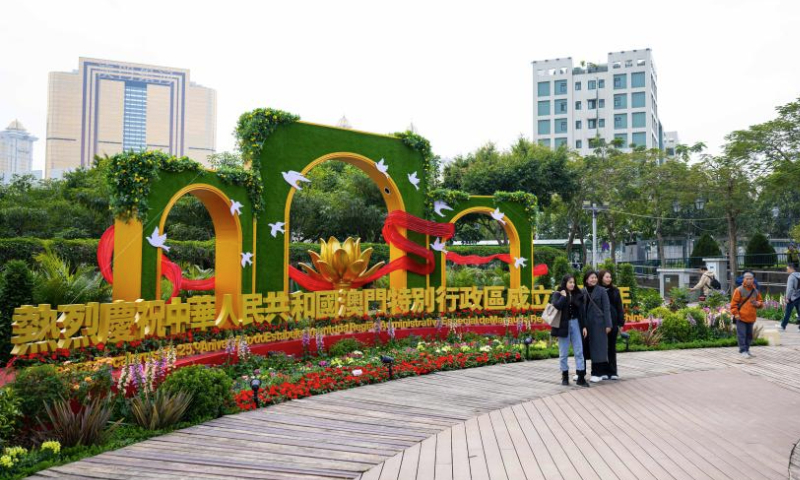 Visitors take photos at a flower show on Taipa Island in Macao, south China, Dec. 14, 2024. A flower show celebrating the 25th anniversary of Macao's return to the motherland kicked off here on Saturday, and will run until Jan. 5, 2025. (Xinhua/Cheong Kam Ka)