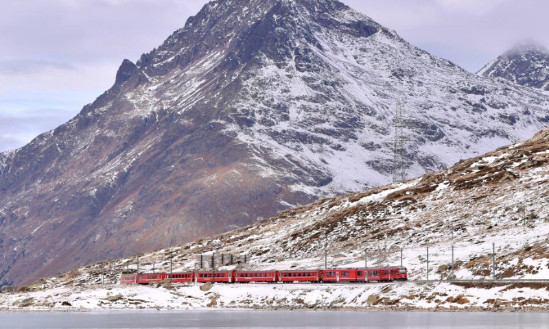 A train runs on the Albula-Bernina railway in Switzerland, Dec. 2, 2024. As a UNESCO World Heritage Site since 2008, the Albula-Bernina railway, one-third of the century-old Rhaetian Railway (RhB), spans 122 km from Thusis, Switzerland, to Tirano, Italy, traversing 196 bridges, 55 tunnels, and 20 towns across alpine landscapes. (Xinhua/Lian Yi)