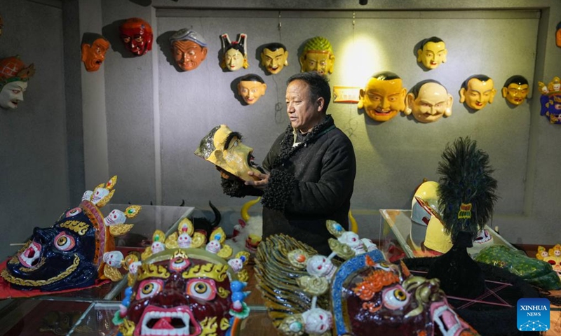 Shilok looks at a traditional Tibetan mask at an exhibition hall of a cooperative in Dagze District of Lhasa, southwest China's Xizang Autonomous Region, Dec. 9, 2024. (Photo: Xinhua)